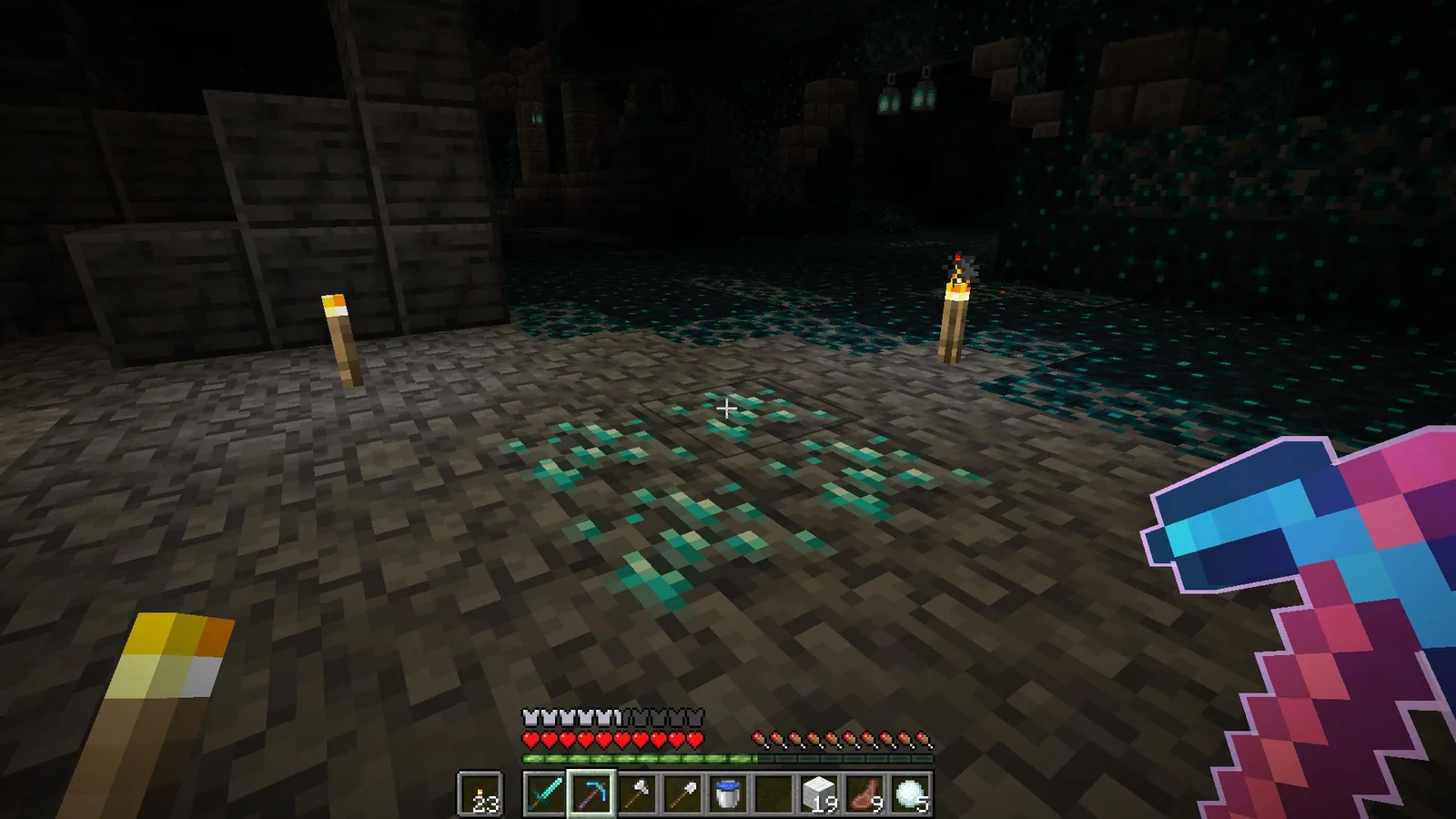Player mining ancient debris with an outlined enchanted pickaxe