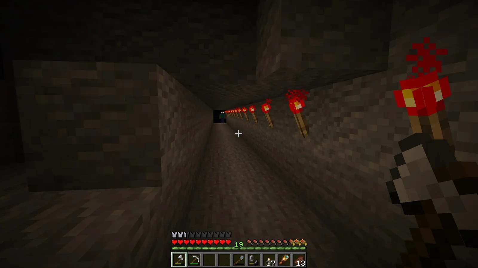 Narrow unlit tunnel carved into a hillside