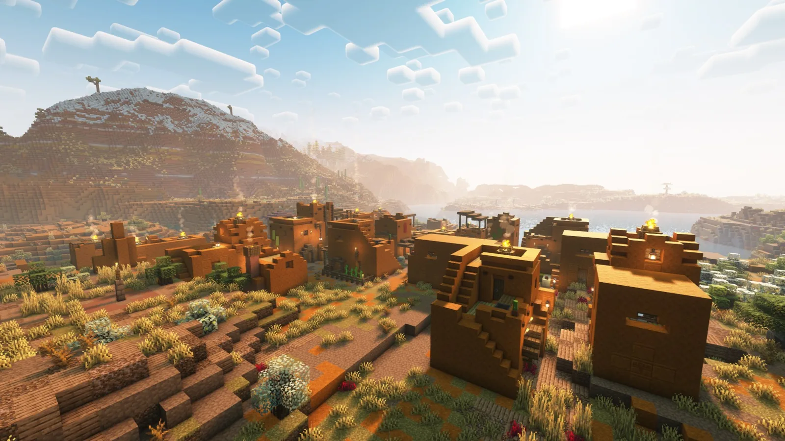 Village built into badlands terrain with terracotta buildings