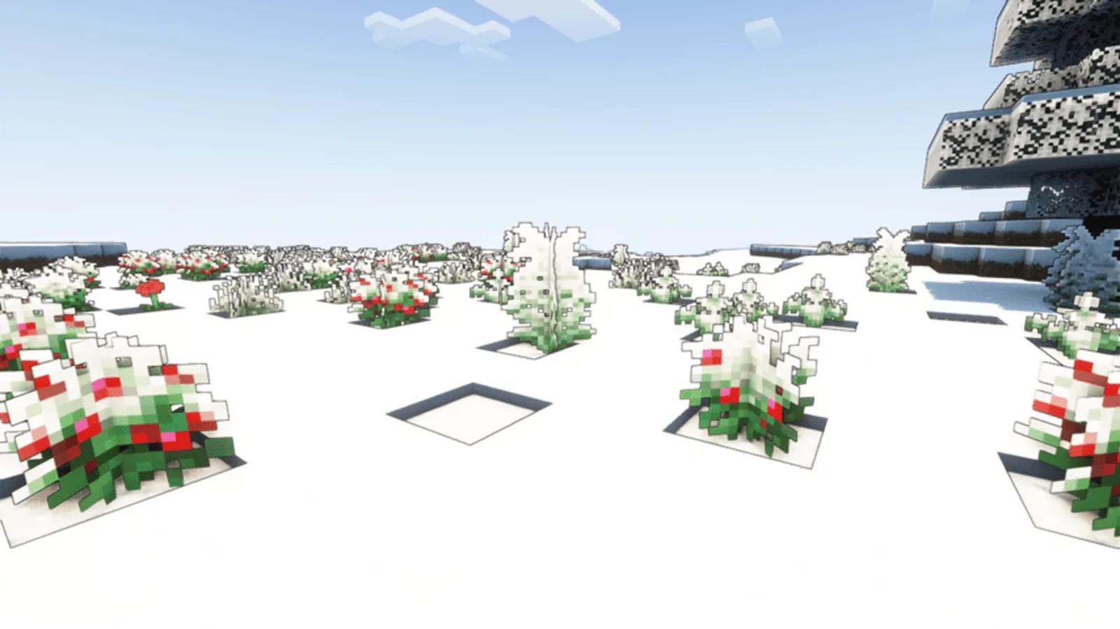 Snowy Minecraft coastline beside frozen water